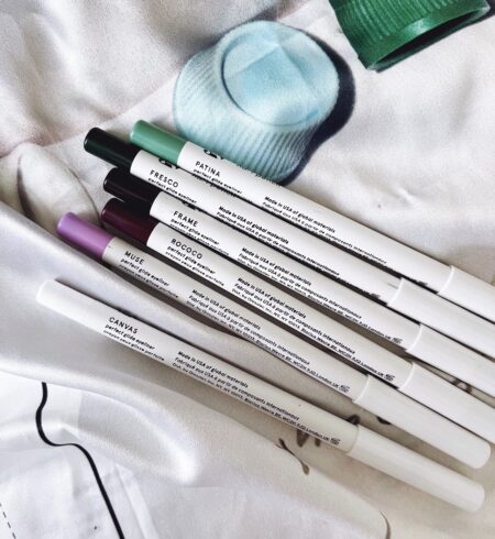 Flat lay of Glossier eyeliners in assorted shades by The Beauty Minimalist